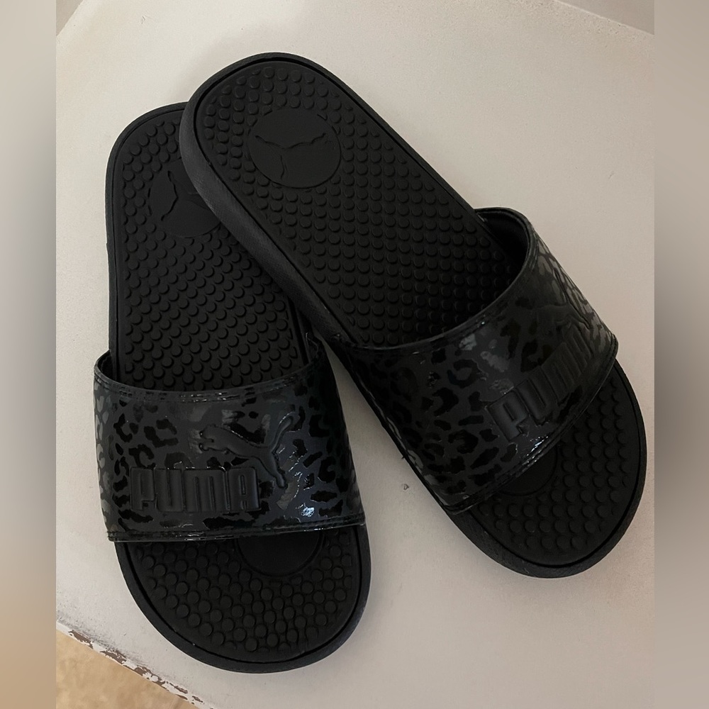 Women’s Puma slides; black cheetah print.  New without tags.